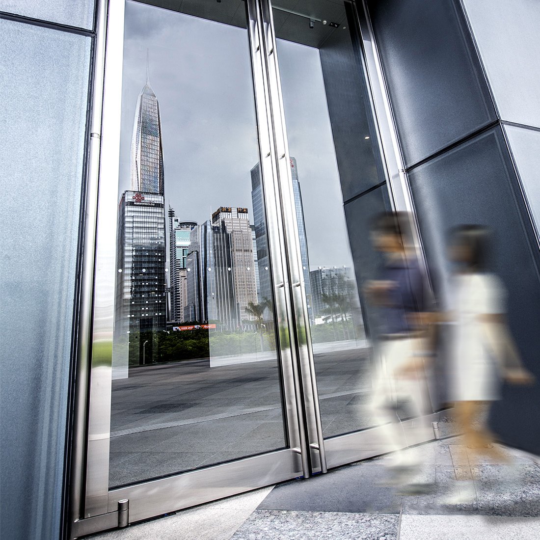 MANLONG balance door installed at a commercial tower entrance